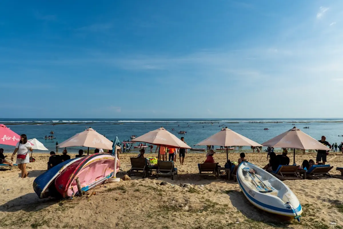 A handcrafted teak phinisi cabin and sun deck arranged for a honeymoon couple