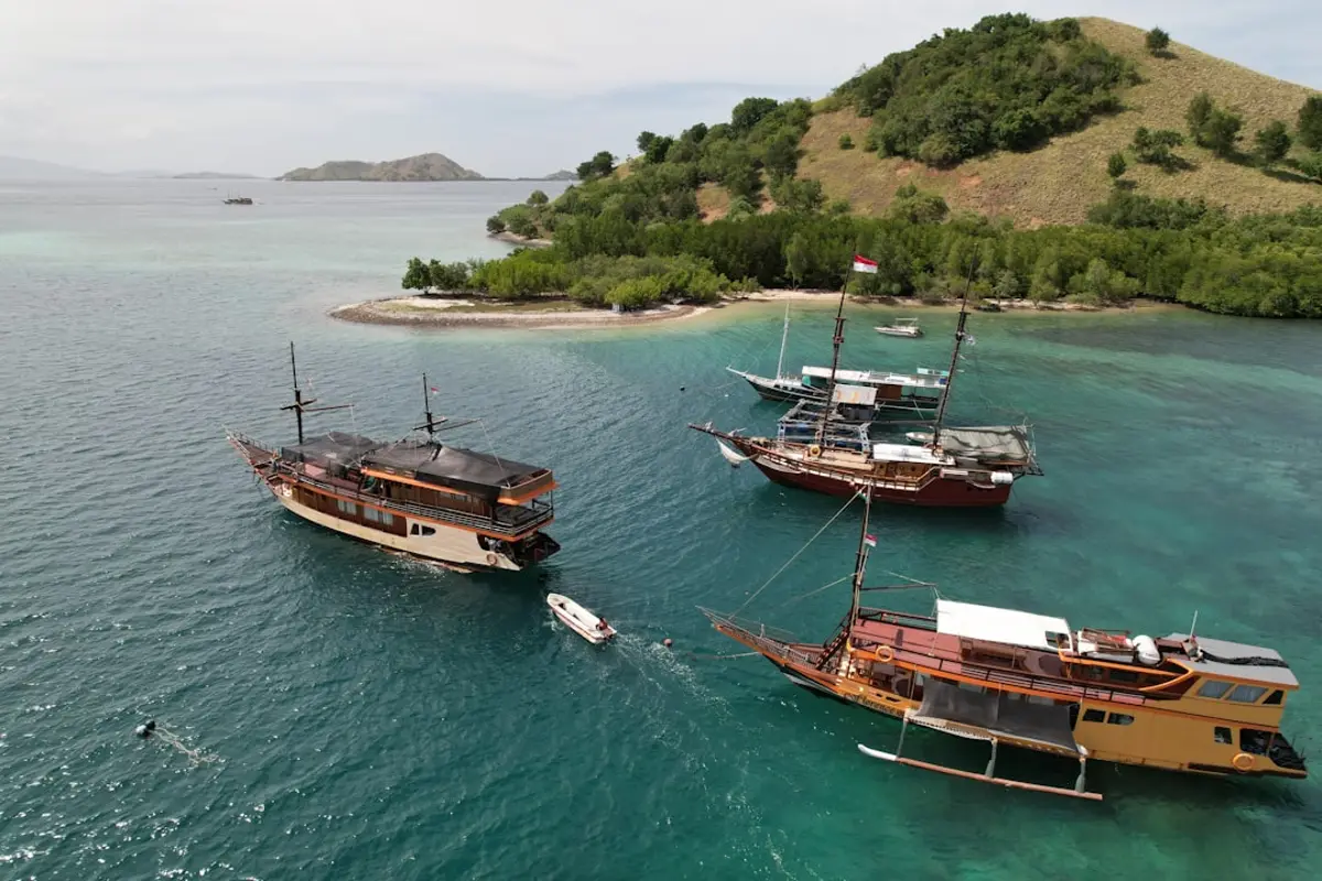 Traditional Indonesian phinisi liveaboard yacht on turquoise water in Komodo and Raja Ampat